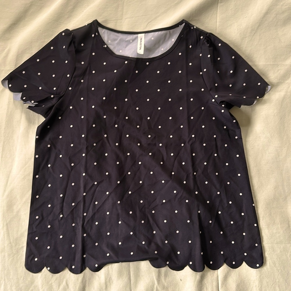 Polka dot top with scalloped sleeves and bottom hem